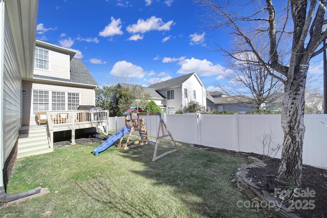 view of yard with a fenced backyard, a playground, and a wooden deck