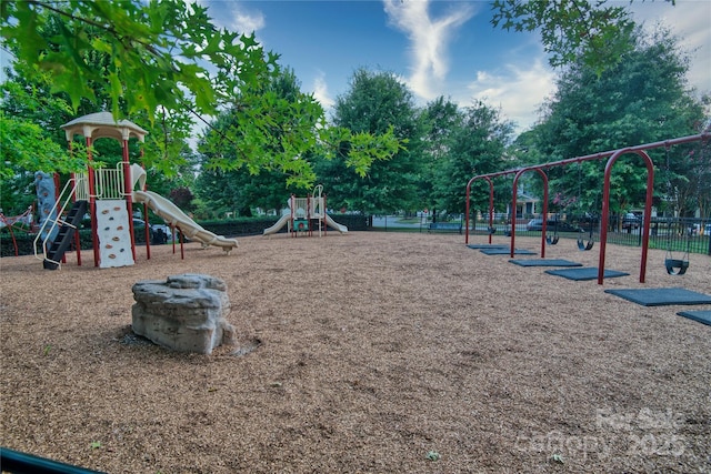 community jungle gym featuring fence