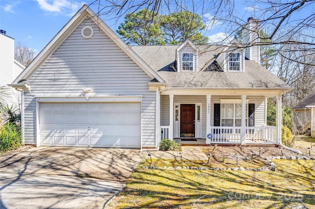 new england style home with a chimney, a shingled roof, covered porch, a garage, and driveway