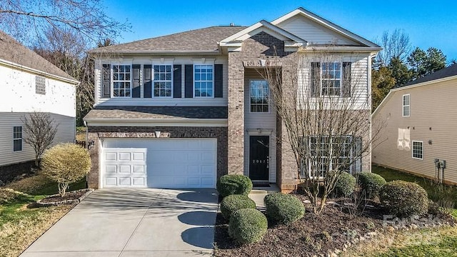 view of front of home with a garage, concrete driveway, brick siding, and a shingled roof