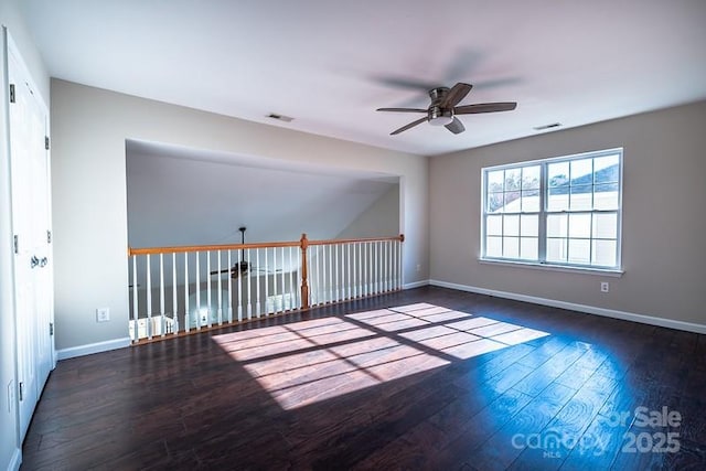 unfurnished room with a ceiling fan, baseboards, visible vents, and wood finished floors