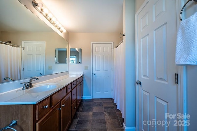 full bathroom with baseboards and vanity