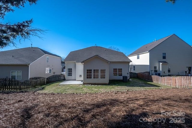 rear view of property featuring a patio area, a fenced backyard, and a lawn