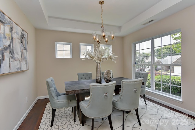 2017 Bridleside Dr, Indian Trail, NC 28079 - dining area featuring a chandelier, a raised ceiling, baseboards, and wood finished floors