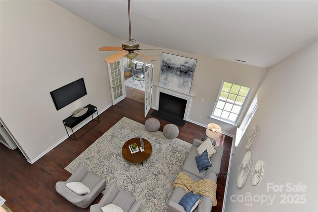 2017 Bridleside Dr, Indian Trail, NC 28079 - living area featuring a ceiling fan, baseboards, a fireplace with flush hearth, and wood finished floors