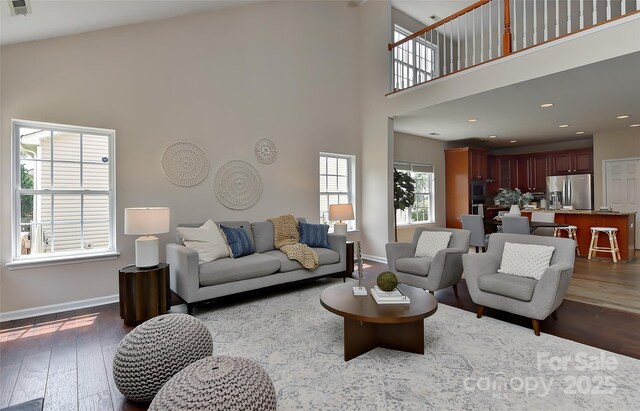 2017 Bridleside Dr, Indian Trail, NC 28079 - living room featuring dark wood-style floors, a high ceiling, baseboards, and recessed lighting