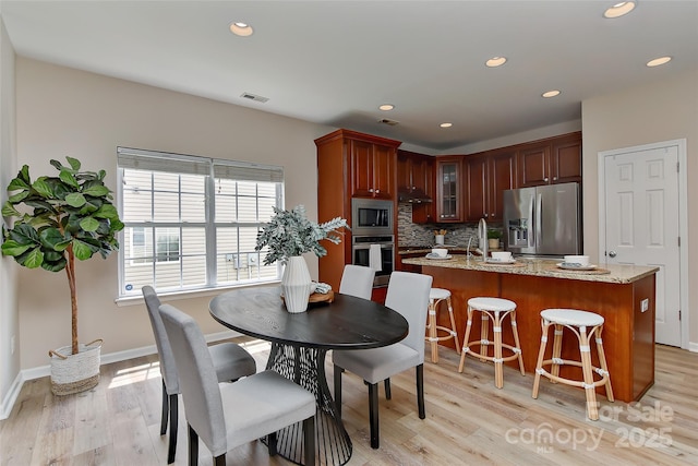 2017 Bridleside Dr, Indian Trail, NC 28079 - dining space with light wood-style flooring, recessed lighting, and baseboards