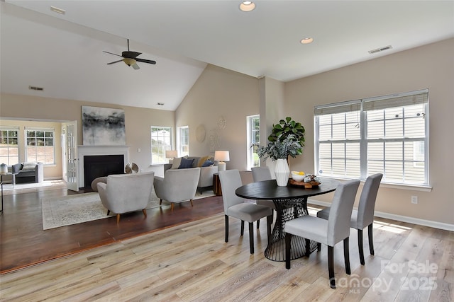 2017 Bridleside Dr, Indian Trail, NC 28079 - dining area featuring plenty of natural light, ceiling fan, a fireplace with flush hearth, wood finished floors, and recessed lighting