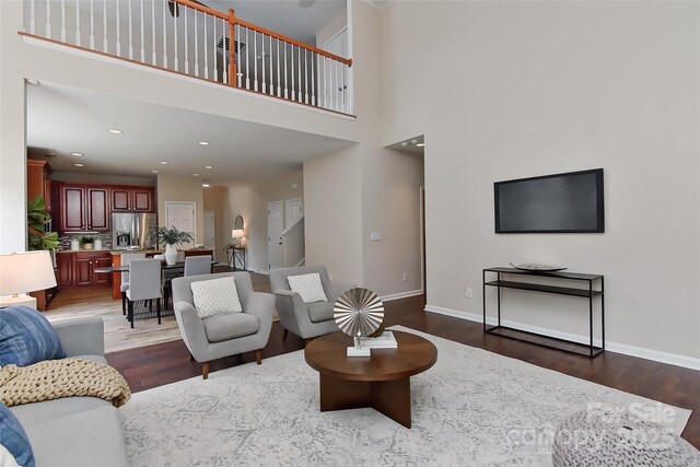 2017 Bridleside Dr, Indian Trail, NC 28079 - living area featuring wood finished floors, baseboards, a towering ceiling, and recessed lighting