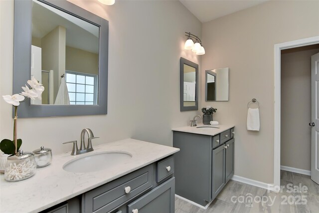 2017 Bridleside Dr, Indian Trail, NC 28079 - full bath featuring two vanities, wood finished floors, baseboards, and a shower