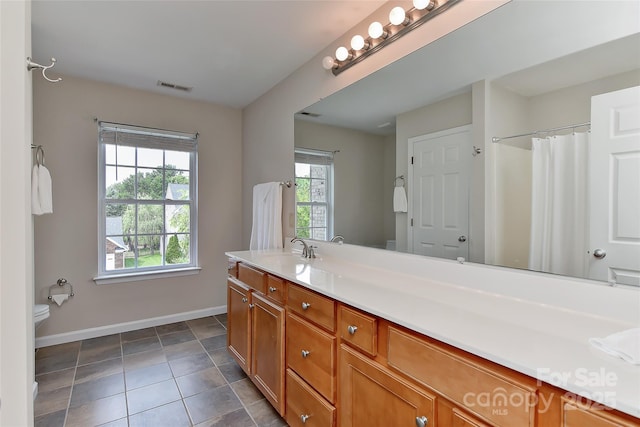 2017 Bridleside Dr, Indian Trail, NC 28079 - full bathroom featuring baseboards, vanity, toilet, tile patterned flooring, and a shower with curtain