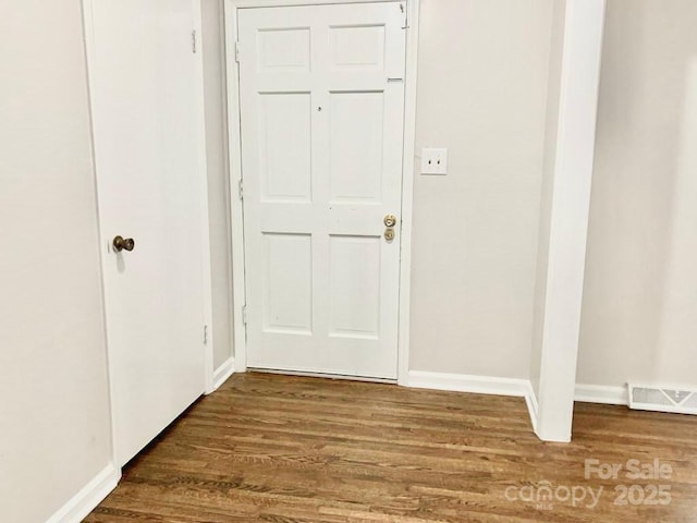 interior space featuring visible vents, baseboards, and wood finished floors