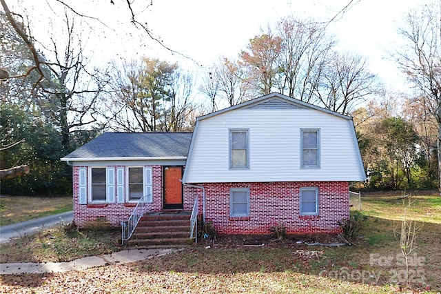 split level home with brick siding and a gambrel roof