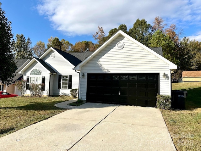 ranch-style home featuring driveway, an attached garage, and a front yard