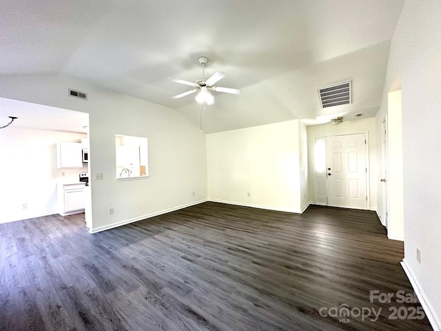 unfurnished living room with lofted ceiling, dark wood-type flooring, and visible vents