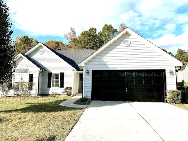 ranch-style house featuring a garage, concrete driveway, and a front lawn