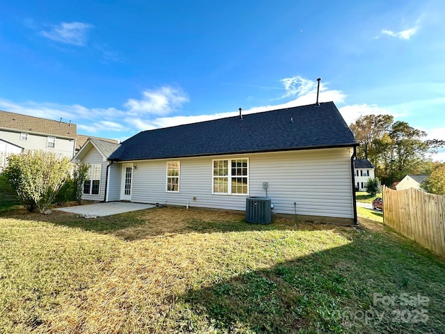 back of property featuring a patio area, central AC unit, and a yard