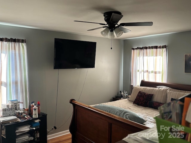 bedroom with light wood-style floors and ceiling fan