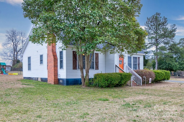 view of front of home with a playground and a front yard