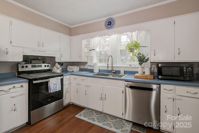 kitchen featuring dark wood-type flooring, under cabinet range hood, a sink, white cabinetry, and stainless steel appliances