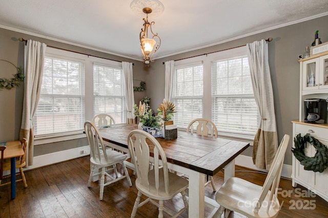 dining area with a healthy amount of sunlight, dark wood-style floors, and crown molding