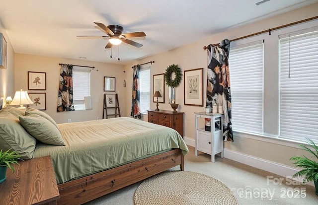 bedroom featuring visible vents, baseboards, carpet floors, and ceiling fan