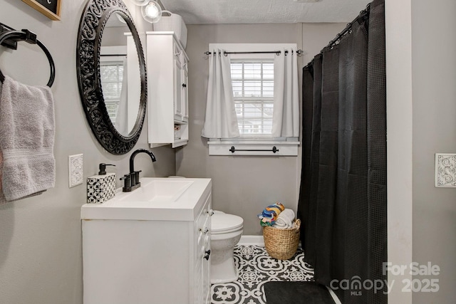 bathroom with vanity, baseboards, curtained shower, tile patterned floors, and toilet