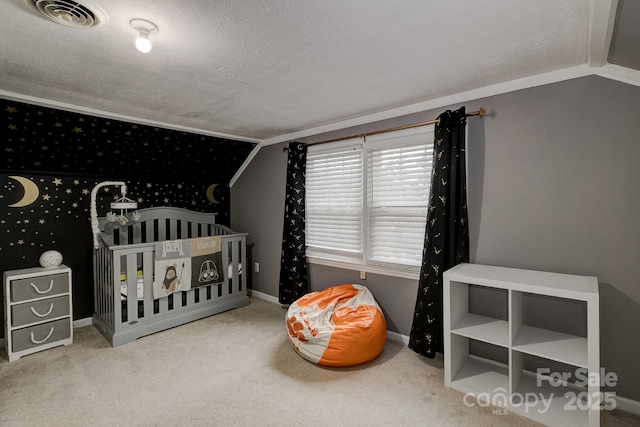 carpeted bedroom with visible vents, a textured ceiling, a nursery area, baseboards, and vaulted ceiling