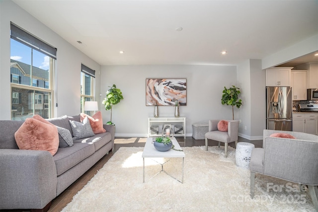 living area featuring recessed lighting, wood finished floors, and baseboards