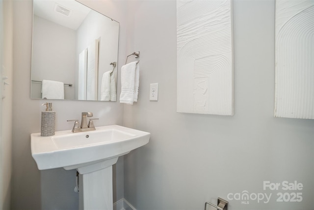 bathroom with visible vents and a sink