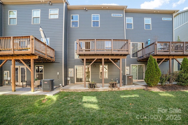 rear view of house featuring a patio area, a lawn, and central air condition unit