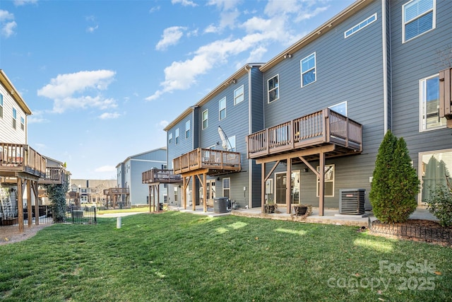 back of house with a lawn and central AC