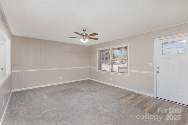 entryway featuring a ceiling fan and carpet flooring