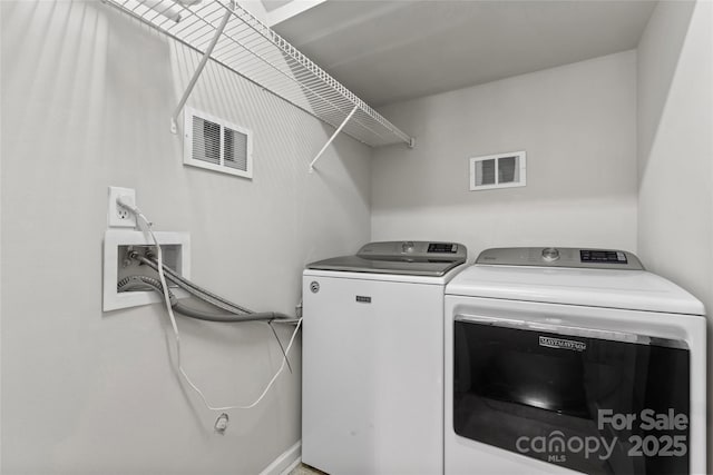 laundry area featuring laundry area, washing machine and dryer, and visible vents