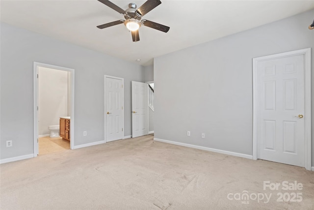 unfurnished bedroom featuring baseboards, ceiling fan, connected bathroom, and light colored carpet