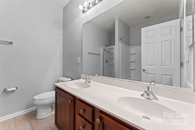 bathroom featuring tile patterned flooring, a sink, toilet, and an enclosed shower