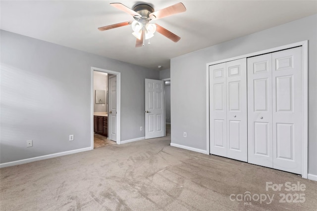 unfurnished bedroom featuring carpet floors, baseboards, and a closet