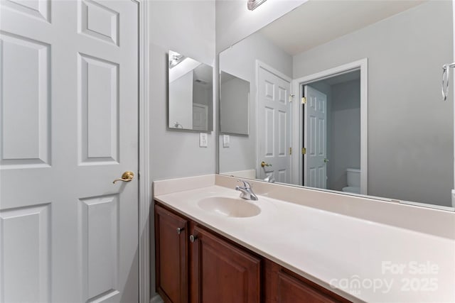 bathroom with toilet and vanity