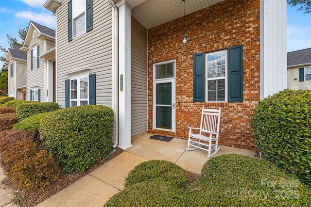 entrance to property with brick siding