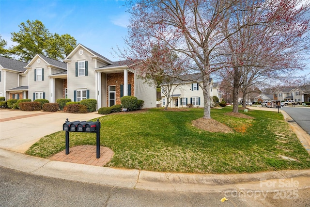 traditional-style house featuring a front yard, brick siding, and a residential view