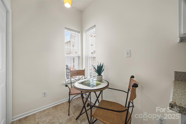 dining area featuring tile patterned flooring and baseboards