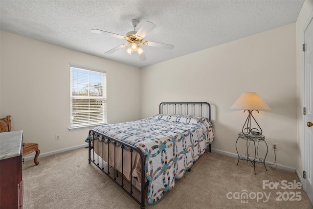 carpeted bedroom with a ceiling fan, a textured ceiling, and baseboards