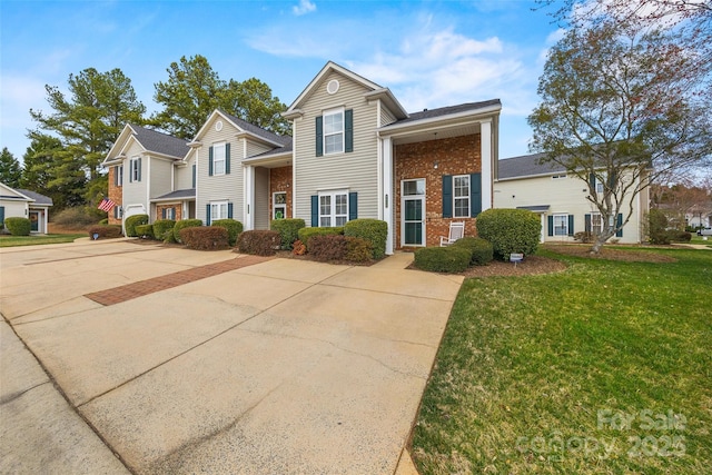 traditional-style house with a front lawn and brick siding