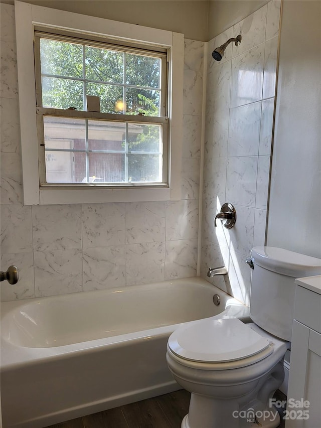 full bathroom with shower / bathtub combination, toilet, wood finished floors, and vanity