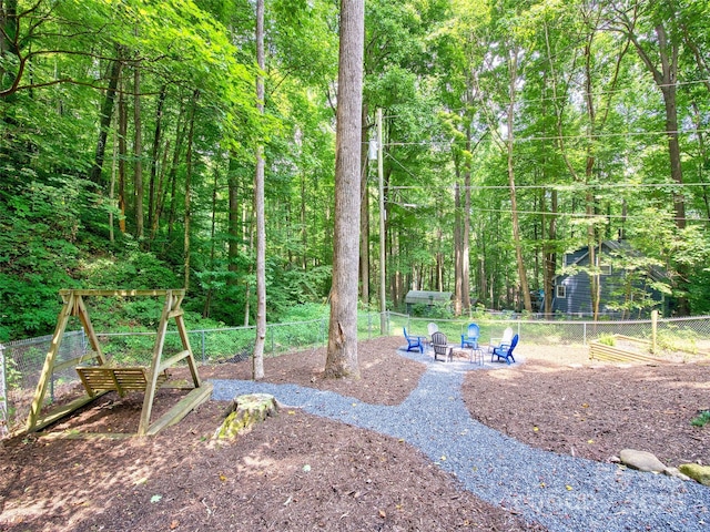 view of yard with fence and a fire pit