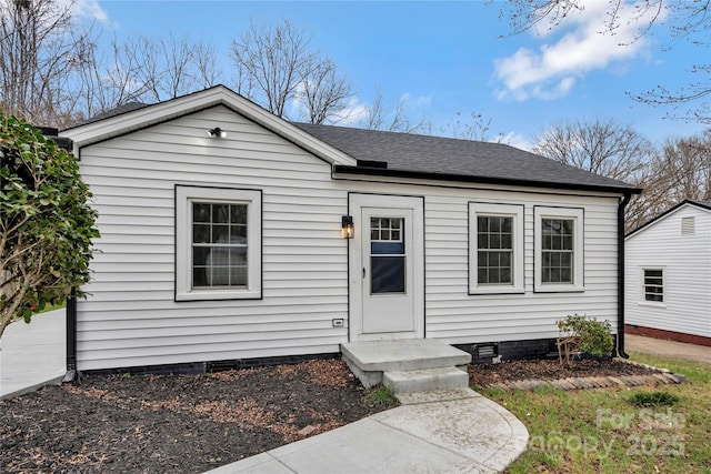 view of front of home featuring crawl space and roof with shingles