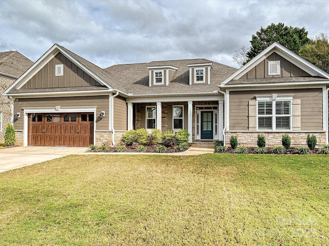 craftsman inspired home featuring driveway, stone siding, board and batten siding, and a front yard