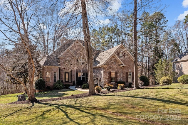 view of front of house with a front lawn and brick siding