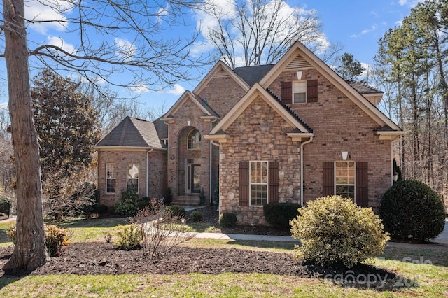 view of front of home featuring stone siding and brick siding