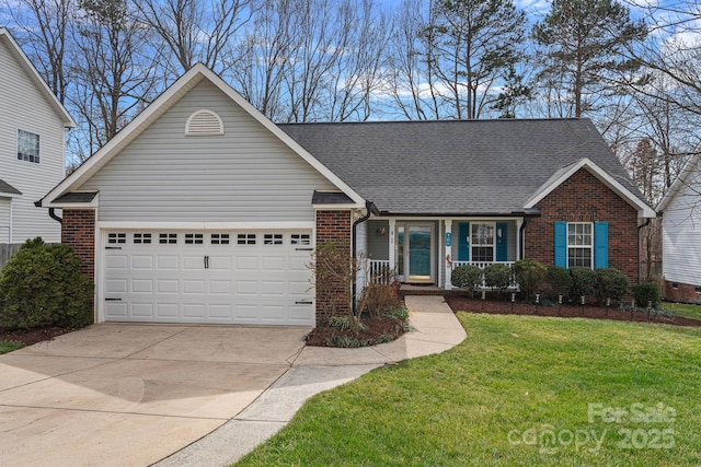 view of front of house featuring a front yard, brick siding, driveway, and an attached garage